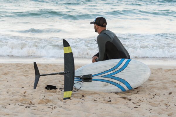 man-holding-surfing-board-outdoors